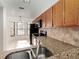 Kitchen with granite countertops, wood cabinets and stainless steel appliances at 7654 Sugar Bend Dr # 7654, Orlando, FL 32819