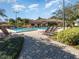 Community pool with lounge chairs and brick-paved walkways at 7654 Sugar Bend Dr # 7654, Orlando, FL 32819