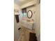 Bathroom featuring neutral sink vanity, decorative mirror and tile flooring at 103 Bougainvillea Dr, Leesburg, FL 34748