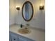 Neutral bathroom sink featuring decorative lighting and mirror at 103 Bougainvillea Dr, Leesburg, FL 34748