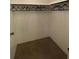 Walk-in closet with ample storage space, rod and shelving for organization at 103 Bougainvillea Dr, Leesburg, FL 34748
