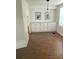 Dining area with wood-look flooring, built-in cabinetry, and natural light streaming in through the window at 103 Bougainvillea Dr, Leesburg, FL 34748
