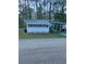 Charming single-story home featuring a carport and freshly landscaped yard at 103 Bougainvillea Dr, Leesburg, FL 34748