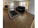 Living room featuring wood-look flooring, area rug, and furniture at 103 Bougainvillea Dr, Leesburg, FL 34748