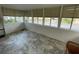 Cozy sun room featuring neutral tile flooring and multiple windows with neutral blinds at 103 Bougainvillea Dr, Leesburg, FL 34748