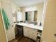 Well-lit bathroom with single sink vanity and a shower with a tub at 106 Royal Palm Dr, Leesburg, FL 34748