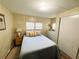 Well-lit bedroom with a comfy bed, side tables, and a dresser for storage at 106 Royal Palm Dr, Leesburg, FL 34748