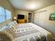 Comfortable bedroom with queen bed, closet, dresser, and wall-mounted television at 106 Royal Palm Dr, Leesburg, FL 34748