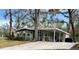 Lovely home features a brick-paved driveway and a charming teal front door at 106 Royal Palm Dr, Leesburg, FL 34748