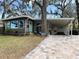 Inviting home with a brick-paved driveway, covered parking, and a cozy, manicured lawn at 106 Royal Palm Dr, Leesburg, FL 34748