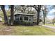 Cozy single-story home with a well-manicured lawn and mature trees at 106 Royal Palm Dr, Leesburg, FL 34748