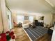 Inviting living room with plush seating, striped rug, wood-look floors, and plenty of natural light at 106 Royal Palm Dr, Leesburg, FL 34748