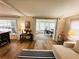 View of open concept living and dining room featuring wood-look floors and modern decor at 106 Royal Palm Dr, Leesburg, FL 34748