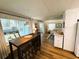Open-concept living area with breakfast bar, neutral decor, and lots of light from window at 106 Royal Palm Dr, Leesburg, FL 34748