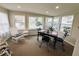 Cozy sunroom offers lots of light, views of the neighborhood, and comfortable seating at 106 Royal Palm Dr, Leesburg, FL 34748