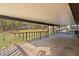 Covered porch with a wood deck overlooking a spacious backyard at 1107 Linmar Ave, Fruitland Park, FL 34731