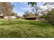 Expansive backyard with outbuildings and sheds, offering ample storage space at 1107 Linmar Ave, Fruitland Park, FL 34731
