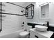 Bathroom features subway tile, black accents, a vessel sink, and modern fixtures at 1107 Linmar Ave, Fruitland Park, FL 34731