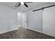 Bedroom with wood-look floors and a sliding barn door at 1107 Linmar Ave, Fruitland Park, FL 34731