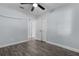 Empty bedroom showing wood-look floors, closet, and doorways to other rooms at 1107 Linmar Ave, Fruitland Park, FL 34731