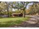 Charming single-story home surrounded by mature trees and greenery, offering a serene and private setting at 1107 Linmar Ave, Fruitland Park, FL 34731