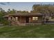 Inviting single-story home with warm wood exterior, front porch, and lush greenery, perfect for a peaceful retreat at 1107 Linmar Ave, Fruitland Park, FL 34731