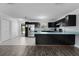 Open kitchen layout featuring a breakfast bar, stainless steel refrigerator, and access to outdoor area at 1107 Linmar Ave, Fruitland Park, FL 34731