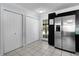 Kitchen with stainless steel refrigerator, white tile floors, and washer dryer at 1107 Linmar Ave, Fruitland Park, FL 34731
