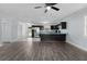 Open concept living area with a ceiling fan, a view of the kitchen, and wood-look flooring at 1107 Linmar Ave, Fruitland Park, FL 34731
