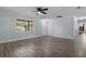 Bright living room featuring wood-look flooring, windows, and neutral-colored walls at 1107 Linmar Ave, Fruitland Park, FL 34731