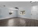 Living room with wood-look flooring, windows, and neutral-colored walls at 1107 Linmar Ave, Fruitland Park, FL 34731