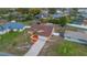 Aerial view of a home with lovely landscaping and in-ground swimming pool in the backyard at 1134 Norwood Dr, Deltona, FL 32725