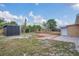 Backyard featuring a patio, shed, and a charming elevated deck at 1134 Norwood Dr, Deltona, FL 32725