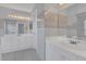Bright bathroom features tiled walls, a large mirror, double sinks, and a shower at 1134 Norwood Dr, Deltona, FL 32725