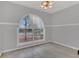 Neutral-colored bedroom with a unique arched window letting in natural light at 1134 Norwood Dr, Deltona, FL 32725