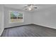 Bedroom with ceiling fan, neutral walls, and dark wood-look floors at 1134 Norwood Dr, Deltona, FL 32725