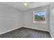 A well lit bedroom with gray walls, wood floors, and a ceiling fan at 1134 Norwood Dr, Deltona, FL 32725