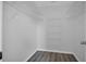 Empty walk-in closet with shelving and dark wood-look floors at 1134 Norwood Dr, Deltona, FL 32725