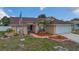 Charming single-story home featuring a well-manicured lawn, American flag, and attached two-car garage at 1134 Norwood Dr, Deltona, FL 32725