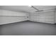 A large garage with storage above and gray painted floors at 1134 Norwood Dr, Deltona, FL 32725