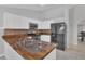 Well-lit kitchen with stainless steel appliances, wood counters, and white cabinetry at 1134 Norwood Dr, Deltona, FL 32725