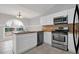 Bright kitchen with white cabinets, stainless appliances, and a large window at 1134 Norwood Dr, Deltona, FL 32725