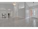 An open-concept living area with tile floors and modern design, leading to the home's entryway at 1134 Norwood Dr, Deltona, FL 32725