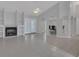 Spacious living room with tile floors, a fireplace, built-in shelving, and large windows at 1134 Norwood Dr, Deltona, FL 32725