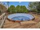 Backyard above-ground swimming pool is boarded by a wooden deck with wooden steps at 1134 Norwood Dr, Deltona, FL 32725