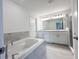 Relaxing bathroom with a soaking tub, double vanity, and glass-enclosed shower at 1212 Caloosa Ridge Ave, Babson Park, FL 33827