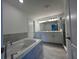 Bright bathroom featuring a soaking tub, double vanity, and tiled floors at 1212 Caloosa Ridge Ave, Babson Park, FL 33827