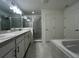 Modern bathroom with a glass-enclosed shower, soaking tub and double sink vanity at 1212 Caloosa Ridge Ave, Babson Park, FL 33827