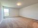 Cozy bedroom with plush carpet, a bright window, and neutral paint at 1212 Caloosa Ridge Ave, Babson Park, FL 33827