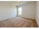 Another neutral carpeted bedroom with a window overlooking the yard at 1212 Caloosa Ridge Ave, Babson Park, FL 33827